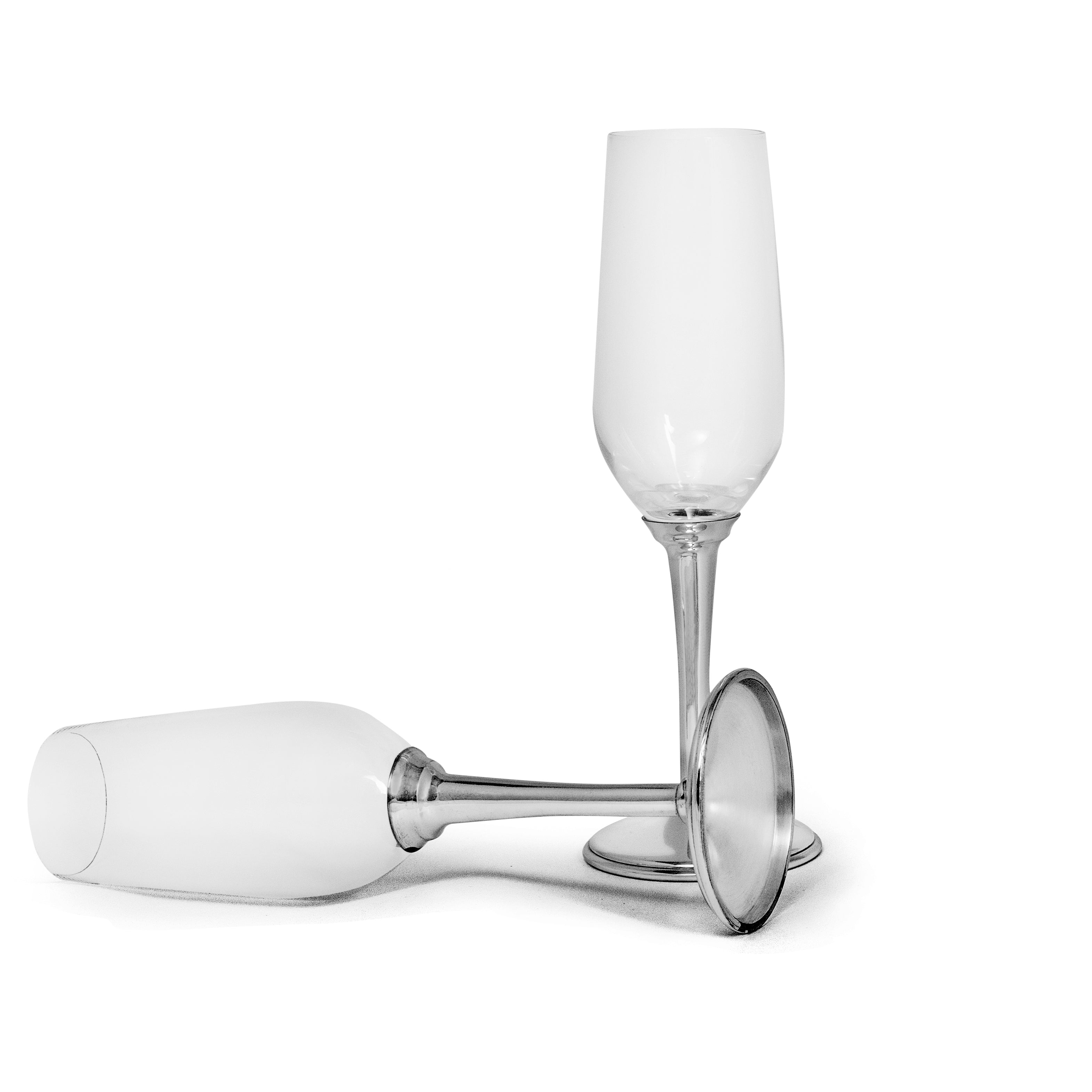 clear glass champagne flute with silver base and stem on a white background