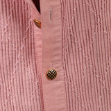 Close-up of a pink textured shirt with buttons
