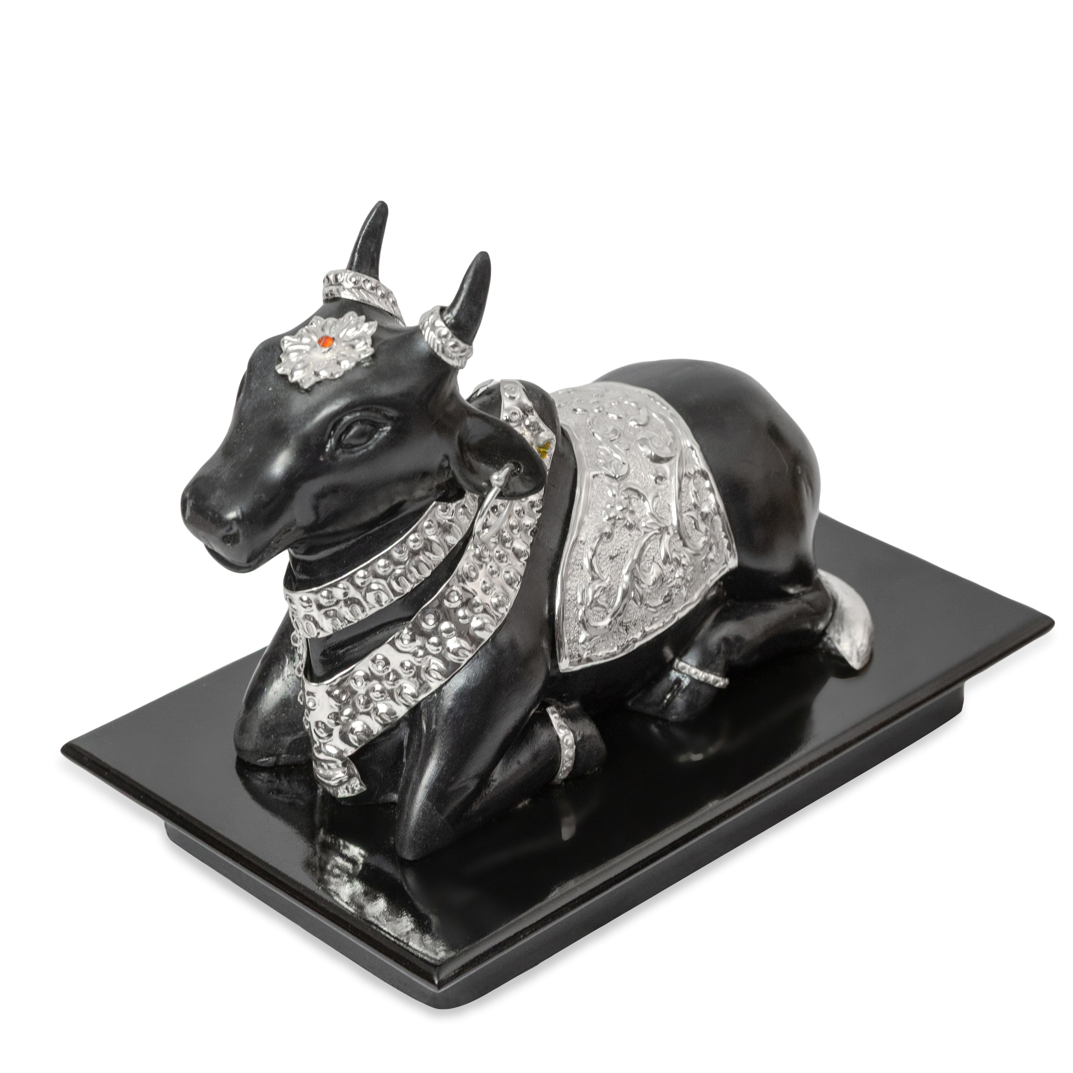 Decorative black bull figurine with silver and crystal embellishments on a white background
